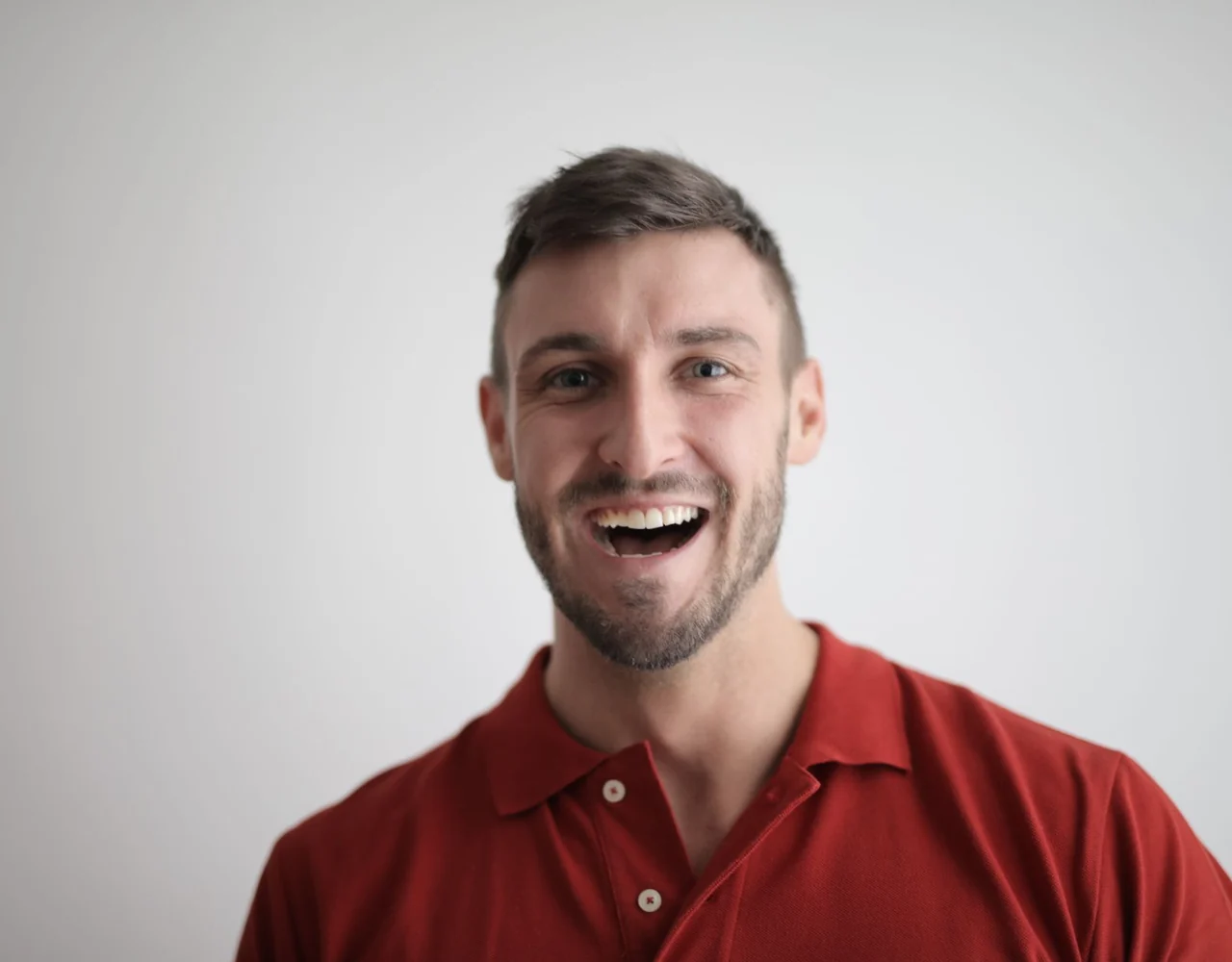 An adult smiling confidently